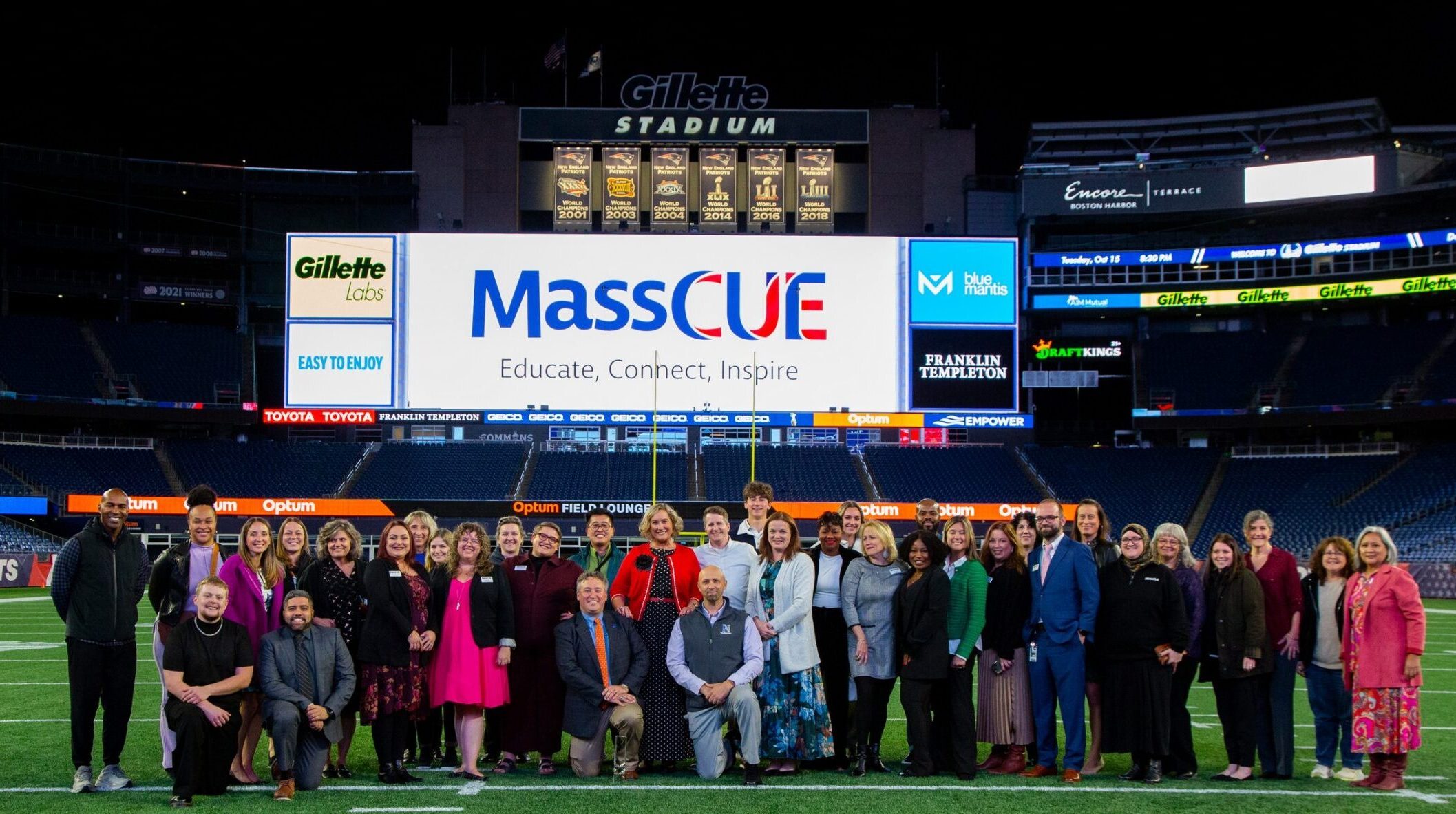 MassCUE Board & Staff and President's Dinner 2024 guests pose for a group photo on Gilette field